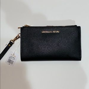 A brand new Michael Kors wristlet purse wallet